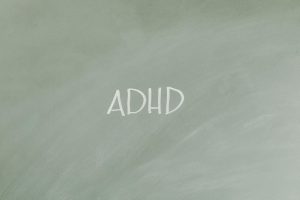Simple illustration highlighting ADHD awareness with text on a gray background.